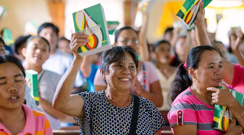 Freude über die eigenen Bibeln: Philippinische Frauen halten ihre Bibeln hoch